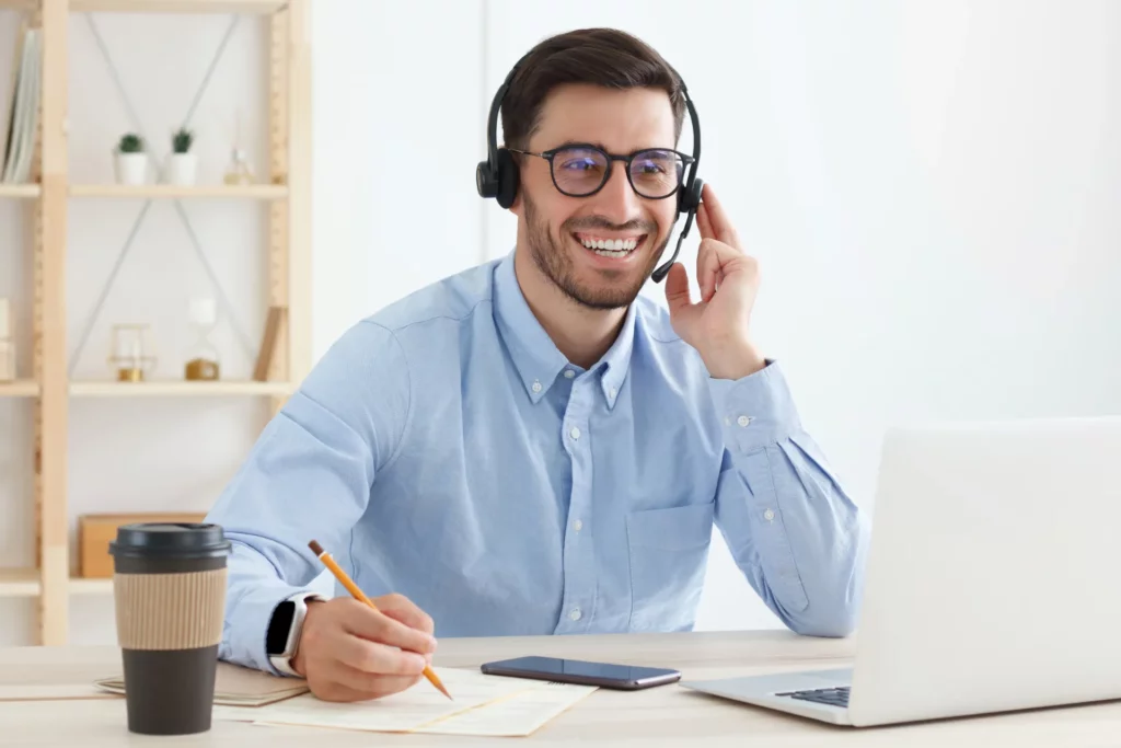 smiling-customer-support-service-operator-with-hand-on-headphones